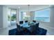 Beautiful dining room with stunning views, a glass table, and access to an outdoor balcony at 1 Seaside Ln # 302, Belleair, FL 33756