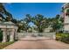 Sea Side property entrance with brick pavers, surrounded by well-maintained landscaping and mature trees at 1 Seaside Ln # 302, Belleair, FL 33756