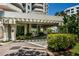 Exterior view of entrance with covered drop-off and well-maintained landscaping at 1 Seaside Ln # 302, Belleair, FL 33756