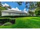 Exterior view of a building surrounded by a trimmed lawn at 1 Seaside Ln # 302, Belleair, FL 33756