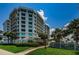 Elegant condominium exterior with well-maintained landscaping and beautiful sky at 1 Seaside Ln # 302, Belleair, FL 33756