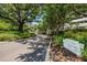 A picturesque view of Sea Side Guest Entrance, lined with mature trees and lush greenery at 1 Seaside Ln # 302, Belleair, FL 33756