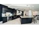 Stunning kitchen with a large island, custom cabinets, and stainless steel appliances at 1 Seaside Ln # 302, Belleair, FL 33756