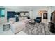 Spacious living area with stylish decor, including a comfortable sofa and plush rug at 1 Seaside Ln # 302, Belleair, FL 33756