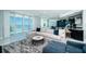 Open-concept living room boasts large windows and access to kitchen and balcony with scenic waterfront view at 1 Seaside Ln # 302, Belleair, FL 33756