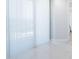Bright interior living space featuring elegant marble floors and sheer curtains filtering natural light at 1 Seaside Ln # 302, Belleair, FL 33756