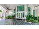 The lobby entrance features a tiled entryway, manicured landscaping, and a glass front door at 1 Seaside Ln # 302, Belleair, FL 33756