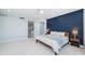 Spacious main bedroom featuring a striking blue accent wall, plush carpeting, and ensuite bathroom entrance at 1 Seaside Ln # 302, Belleair, FL 33756