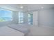 Bright main bedroom featuring ocean views, a ceiling fan, and access to a balcony at 1 Seaside Ln # 302, Belleair, FL 33756