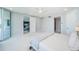 Spacious main bedroom offering balcony access, an open door to living spaces, and ample natural light at 1 Seaside Ln # 302, Belleair, FL 33756