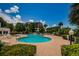 Relaxing kidney-shaped pool with brick patio, surrounded by lush landscaping and comfortable lounge chairs at 1 Seaside Ln # 302, Belleair, FL 33756