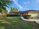 Attractive single-story home with brick facade, green lawn, and well-maintained landscaping at 1011 Mallow Way, Brandon, FL 33510