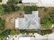 Aerial view of roof and partially shaded backyard with lush landscaping at 10703 59Th Ave, Seminole, FL 33772