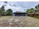 This backyard features screened-in porch and surrounding trees at 10703 59Th Ave, Seminole, FL 33772
