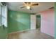 The bedroom features dual toned walls, a ceiling fan and speckled floor at 10703 59Th Ave, Seminole, FL 33772