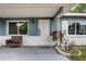 Inviting front porch with seating, stylish decor, and well-manicured landscaping at 10703 59Th Ave, Seminole, FL 33772