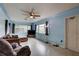Bright living room with a ceiling fan, large windows, and comfortable furnishings at 10703 59Th Ave, Seminole, FL 33772