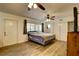 This cozy bedroom features a ceiling fan, hardwood floors, and natural light throughout the room at 10703 59Th Ave, Seminole, FL 33772