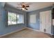 This room features natural light, a ceiling fan, and a convenient side door access to the outside of the house at 10703 59Th Ave, Seminole, FL 33772