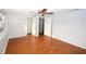 A bedroom with laminate wood floors, a ceiling fan, closet, and ensuite bathroom at 10740 Oldham Rd, Port Richey, FL 34668