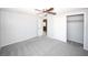A bright bedroom featuring neutral walls, carpet, closet, and ensuite bathroom at 10740 Oldham Rd, Port Richey, FL 34668