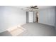 A neutral colored bedroom features carpet, ceiling fan, and ensuite bath at 10740 Oldham Rd, Port Richey, FL 34668