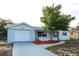 Charming single-story home with a well-maintained lawn and attached garage at 10740 Oldham Rd, Port Richey, FL 34668