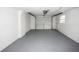 Spacious garage with painted floor, automatic door opener, and room for storage at 10740 Oldham Rd, Port Richey, FL 34668