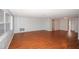 Bright living room featuring gleaming hardwood floors and neutral paint at 10740 Oldham Rd, Port Richey, FL 34668