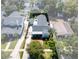 Birds eye view of a home showing the brick paver drive, detached garage, fenced backyard, and lush landscaping at 115 S Beverly Ave, Tampa, FL 33609