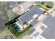 Stunning aerial view of the backyard featuring a luxurious pool, patio, dining area, and well-manicured landscaping at 115 S Beverly Ave, Tampa, FL 33609
