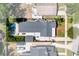 Aerial view of the property featuring a pool, patio, and well-manicured lawn at 115 S Beverly Ave, Tampa, FL 33609