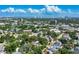 Aerial view of the neighborhood with lush trees, blue skies, city views, and highlighting proximity to businesses at 115 S Beverly Ave, Tampa, FL 33609