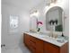Elegant bathroom with double vanities, gold fixtures, and ample natural light at 115 S Beverly Ave, Tampa, FL 33609