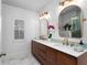 Stylish bathroom featuring double sinks, gold fixtures, and modern design at 115 S Beverly Ave, Tampa, FL 33609