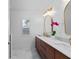 Bright bathroom featuring double sinks, gold fixtures, and a stylish orchid at 115 S Beverly Ave, Tampa, FL 33609