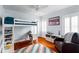 Bright bedroom featuring hardwood floors, a loft bed, and ample natural light at 115 S Beverly Ave, Tampa, FL 33609