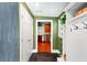 Entryway features a view of the kitchen, slate floors, and a built-in storage cabinet at 115 S Beverly Ave, Tampa, FL 33609