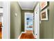 Hallway view leads to a bedroom with light blue walls and a playful rug at 115 S Beverly Ave, Tampa, FL 33609