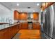 Updated kitchen features stainless steel appliances, granite countertops, and hardwood floors at 115 S Beverly Ave, Tampa, FL 33609