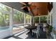 Beautiful screened lanai featuring wood ceiling with fans, comfortable seating and a view to the pool at 115 S Beverly Ave, Tampa, FL 33609