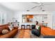 The living room features hardwood floors, and opens into a modern kitchen with stainless steel appliances at 115 S Beverly Ave, Tampa, FL 33609
