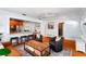The living room features hardwood floors, and opens into a modern kitchen with stainless steel appliances at 115 S Beverly Ave, Tampa, FL 33609
