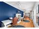 Home office features hardwood floors, natural light, and a view into the living room at 115 S Beverly Ave, Tampa, FL 33609