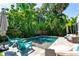 Lush tropical backyard with a sparkling pool, perfect for relaxation and outdoor entertainment at 115 S Beverly Ave, Tampa, FL 33609