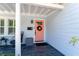 Inviting porch offers charming seating area, stylish tile flooring, and a brightly colored front door at 115 S Beverly Ave, Tampa, FL 33609