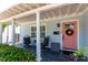 Inviting porch offers charming seating area, stylish tile flooring, and a brightly colored front door at 115 S Beverly Ave, Tampa, FL 33609