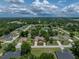 Aerial view showcases this home's large lot, mature trees, and attractive landscaping in established neighborhood at 11530 Arlhuna Way, Dade City, FL 33525