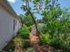 Mature landscaping in backyard featuring shed and ample space at 11530 Arlhuna Way, Dade City, FL 33525