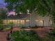 Charming backyard at dusk featuring lush garden and tranquil outdoor space at 11530 Arlhuna Way, Dade City, FL 33525